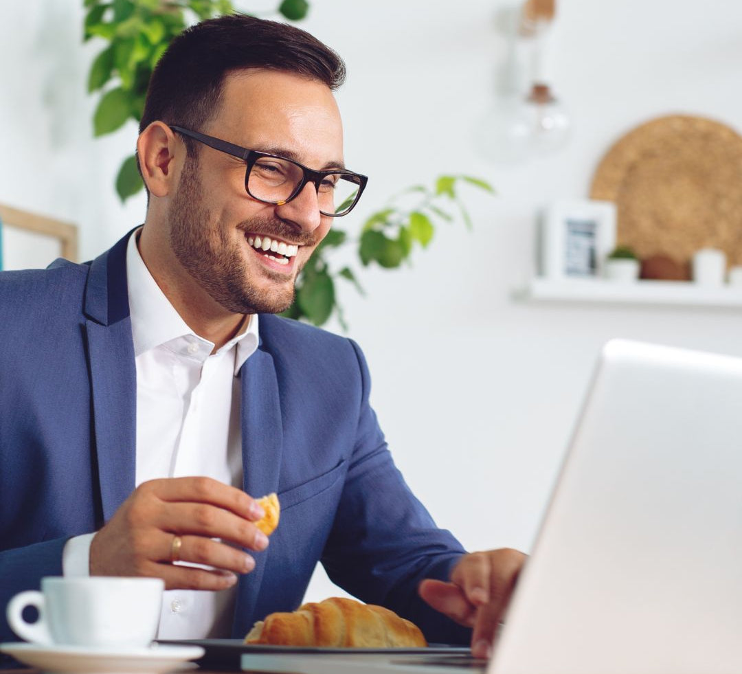 Happy professional working on computer – GeneIII antioxidant capsules for focus and vitality