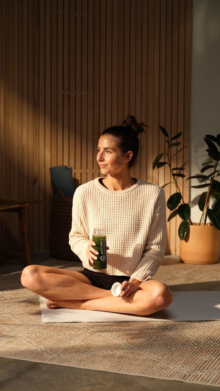 Person relaxing at home with a GeneIII supplement drink